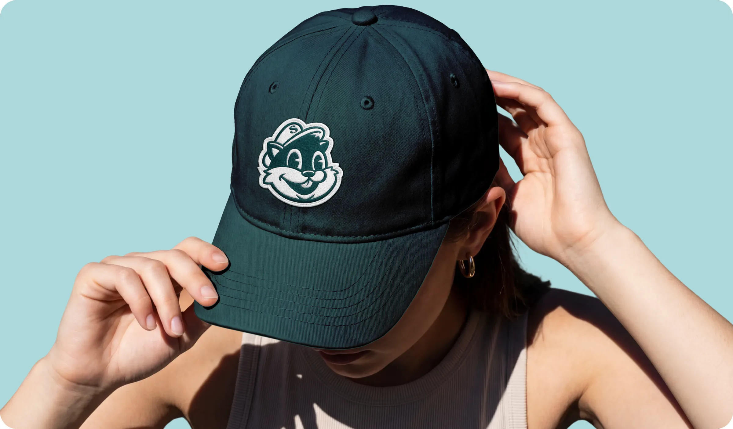 A dark green cap embroidered with the Shippy mascot