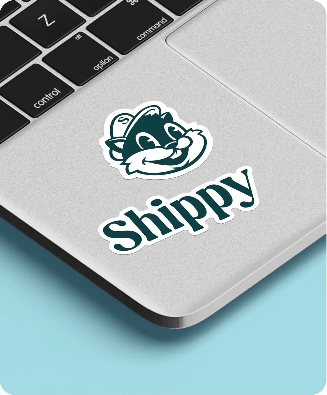 A Shippy mascot and wordmark sticker on a laptop