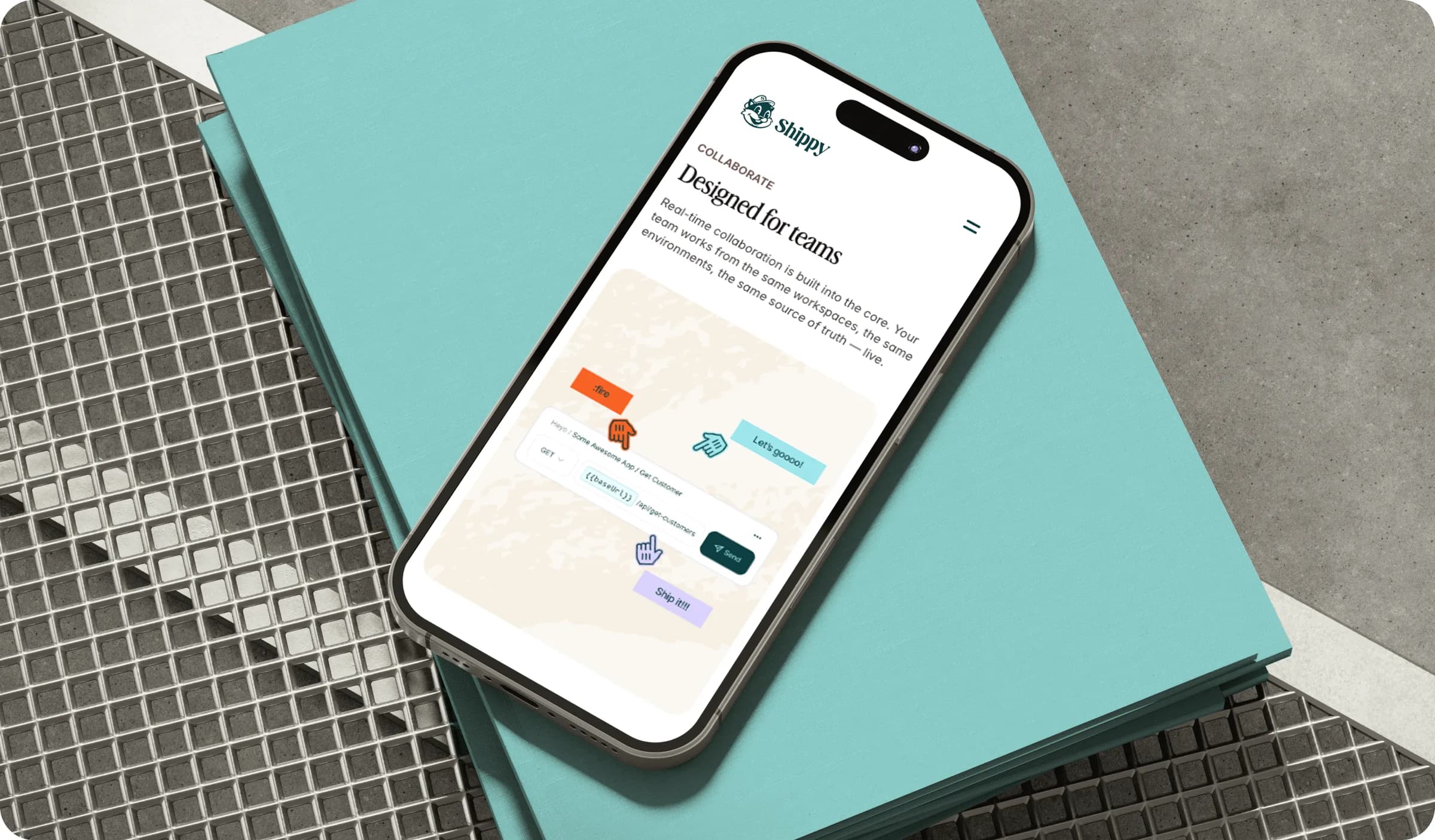 The shippy.app collaboration page on a phone resting on a notebook
