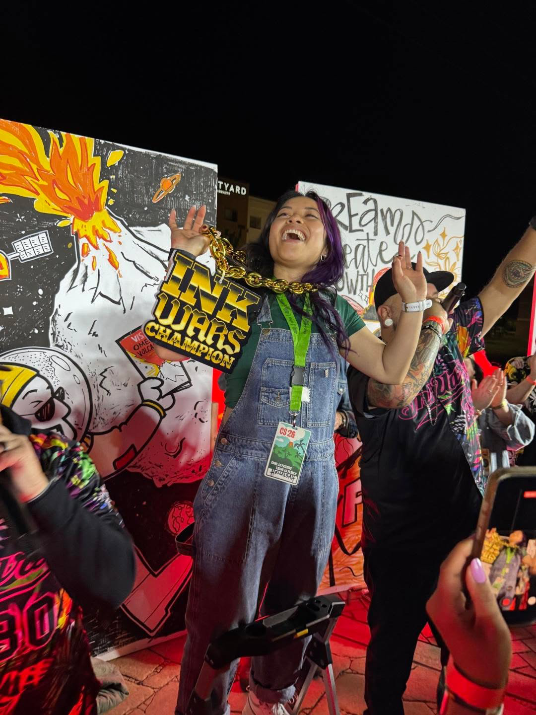 Ink Wars champion celebrating victory at the Creative South 2026 bridge party